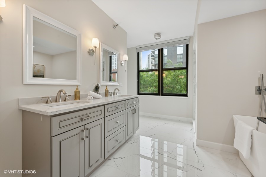 55 West Delaware Place, Unit 415 Chicago, IL 60610 - Photo 24 of 41 a bathroom with a tub sink and mirror