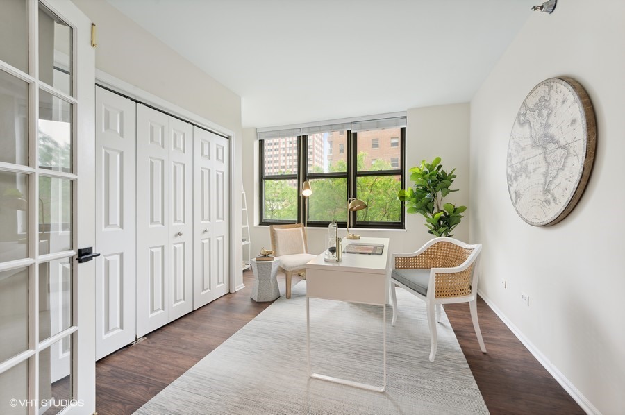 55 West Delaware Place, Unit 415 Chicago, IL 60610 - Photo 26 of 41 a living room with furniture a large window and a rug