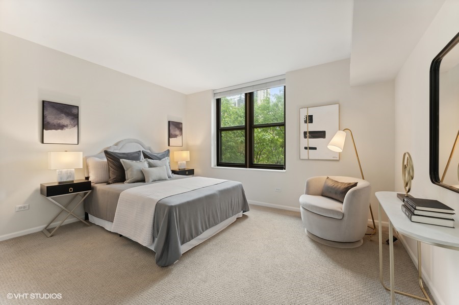 55 West Delaware Place, Unit 415 Chicago, IL 60610 - Photo 27 of 41 a spacious bedroom with a bed and a couch