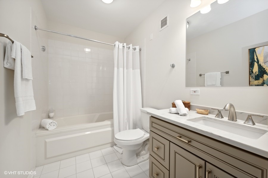 55 West Delaware Place, Unit 415 Chicago, IL 60610 - Photo 28 of 41 a bathroom with a sink a toilet and a bathtub