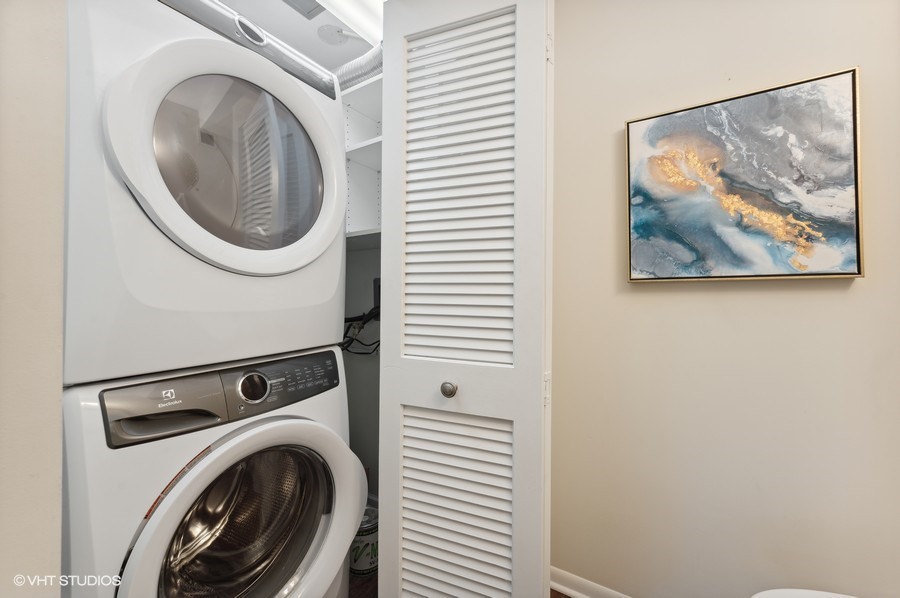 55 West Delaware Place, Unit 415 Chicago, IL 60610 - Photo 29 of 41 a view of a hallway with washer and dryer