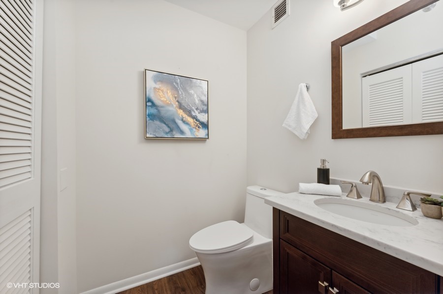 55 West Delaware Place, Unit 415 Chicago, IL 60610 - Photo 31 of 41 a bathroom with a toilet sink and mirror