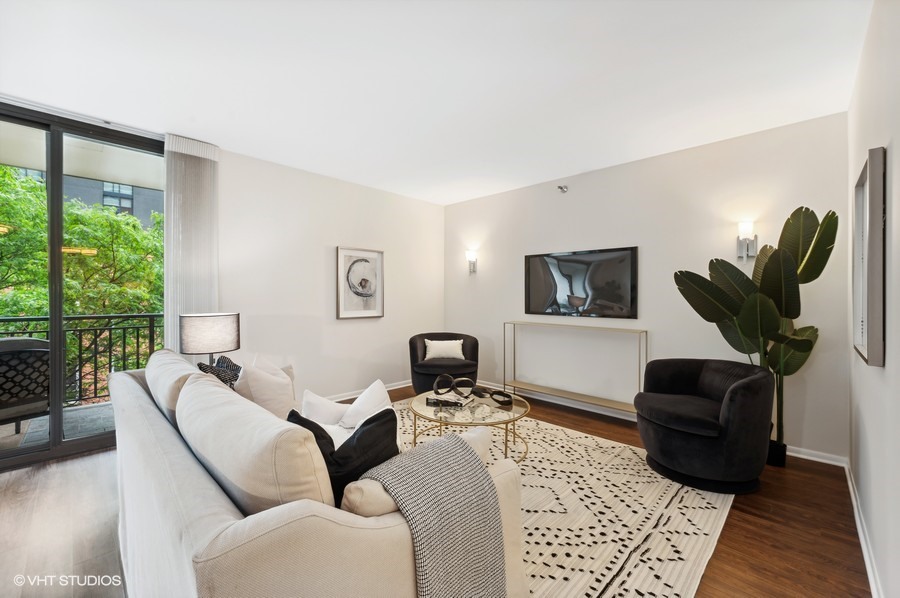 55 West Delaware Place, Unit 415 Chicago, IL 60610 - Photo 5 of 41 a living room with furniture potted plant and a window