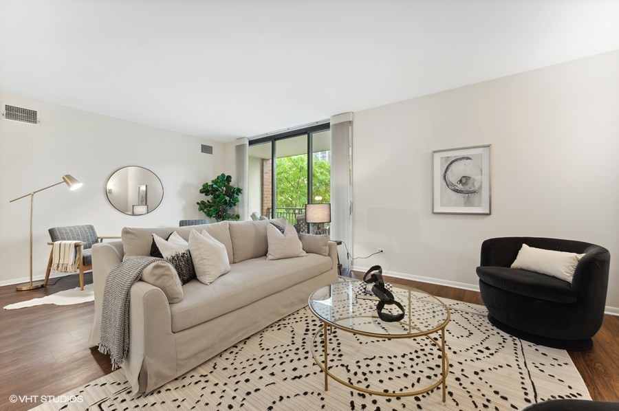 55 West Delaware Place, Unit 415 Chicago, IL 60610 - Photo 6 of 41 a living room with furniture and a window