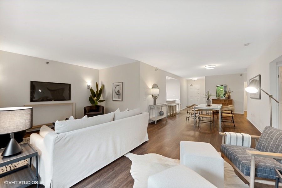 55 West Delaware Place, Unit 415 Chicago, IL 60610 - Photo 7 of 41 a living room with furniture and a flat screen tv