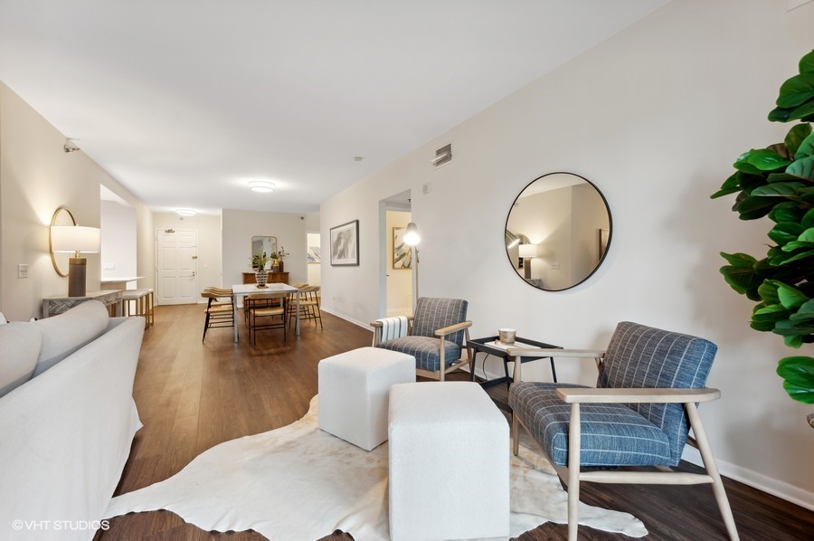 55 West Delaware Place, Unit 415 Chicago, IL 60610 - Photo 8 of 41 a living room with fireplace furniture and a mirror