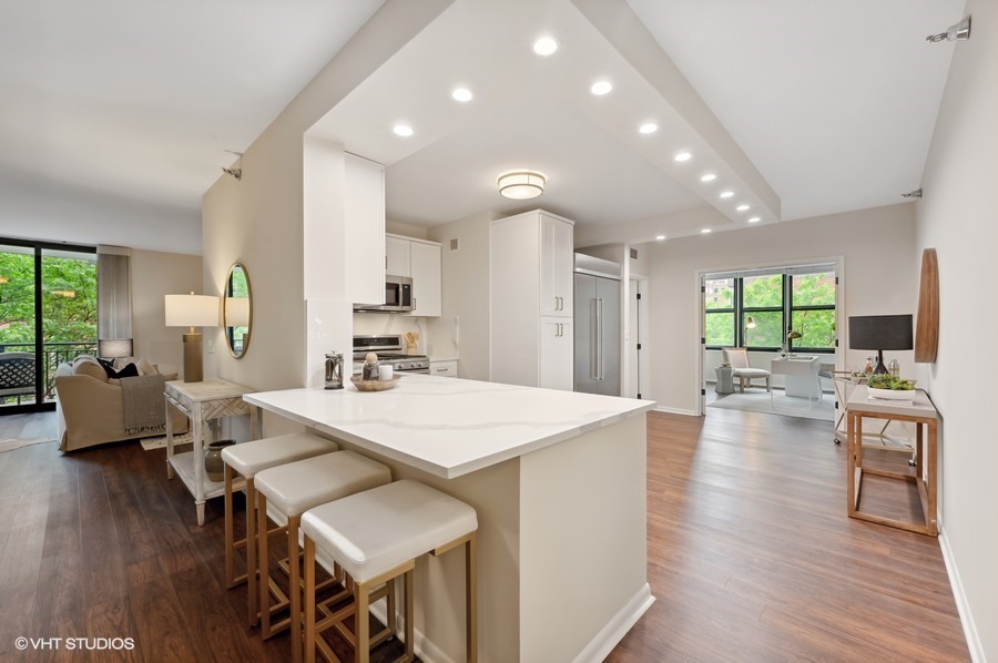 55 West Delaware Place, Unit 415 Chicago, IL 60610 - Photo 9 of 41 a large kitchen with a table and chairs