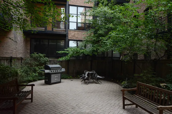 a backyard of a house with yard fire pit barbeque oven and outdoor seating