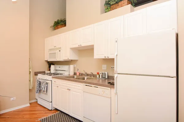 a kitchen with a sink a stove and refrigerator