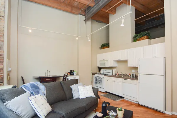 a kitchen with stainless steel appliances kitchen island granite countertop a refrigerator and a stove top oven