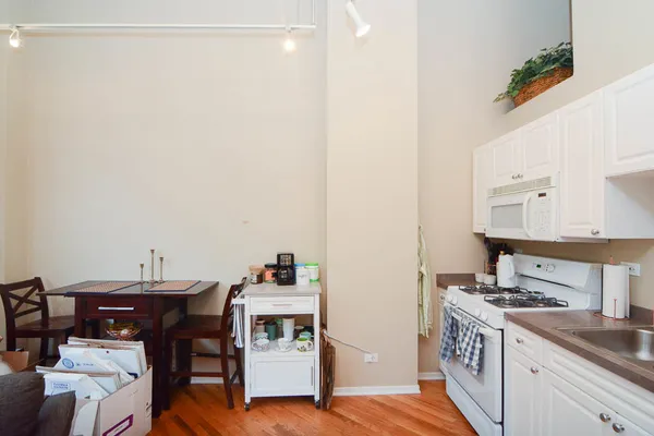 a kitchen with a sink cabinets and stove top oven