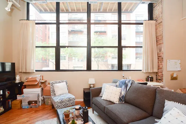 a living room with furniture and large window