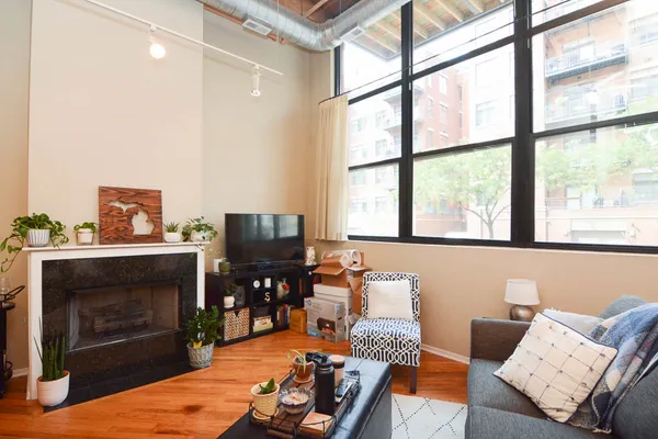 a living room with furniture a flat screen tv and a fireplace