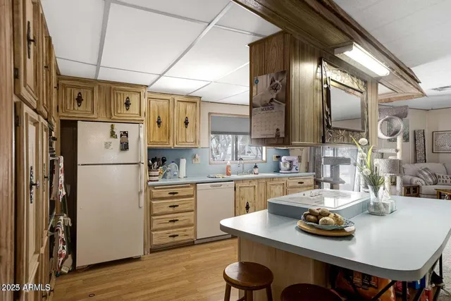 a kitchen with stainless steel appliances granite countertop a sink a stove and a refrigerator