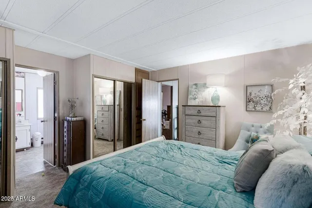 a bedroom with a bed and a dresser