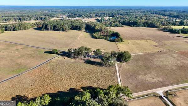 an aerial view of a house with a yard