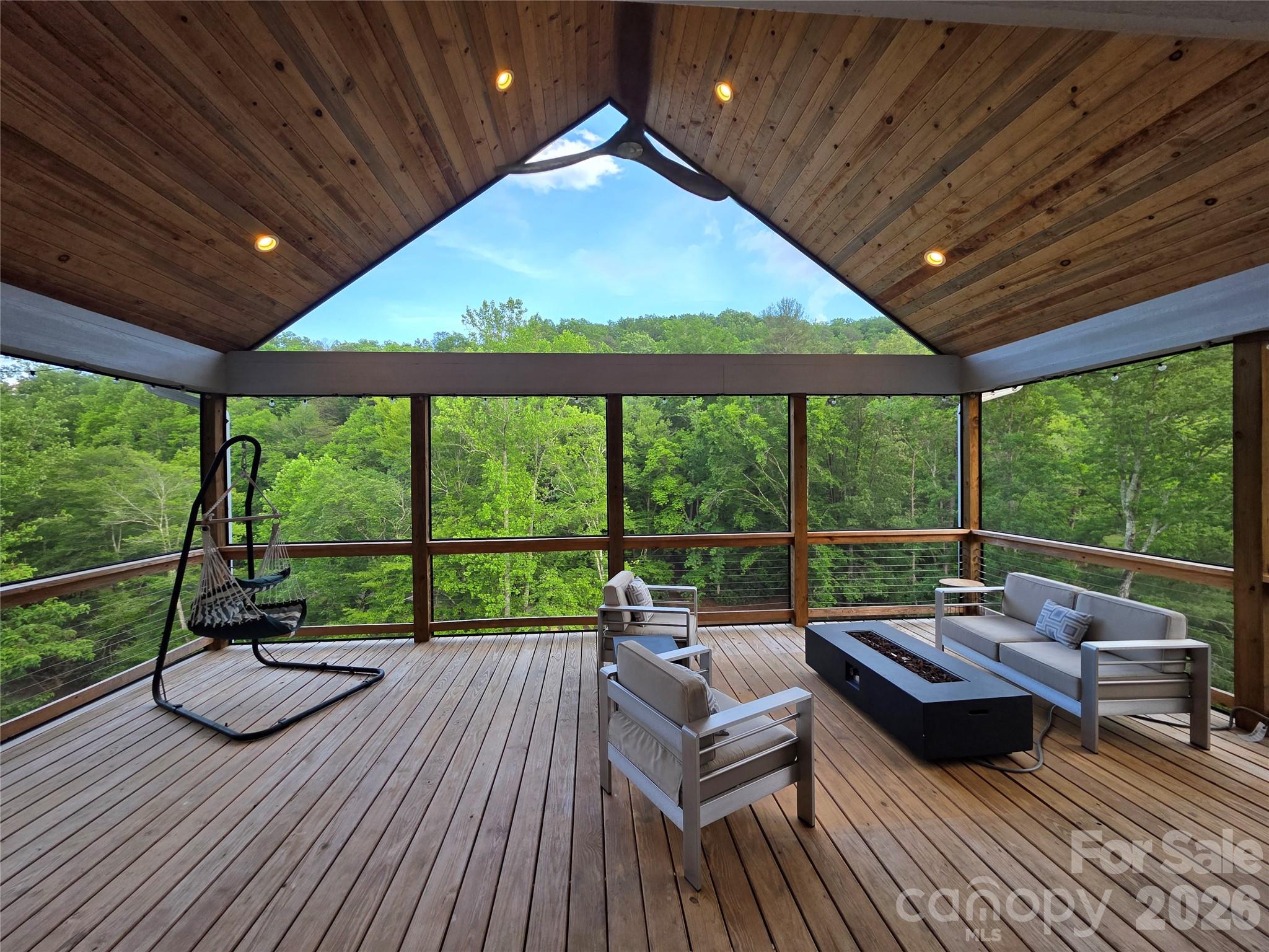 123 Israel Road Candler, NC 28715 - Photo 35 of 44 a sitting area with furniture and wooden deck