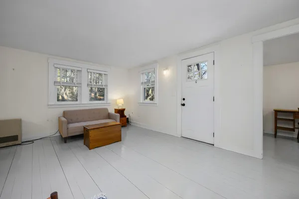an empty room with windows and closet