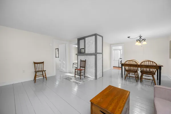 a kitchen with stainless steel appliances granite countertop a sink a stove a refrigerator and white cabinets