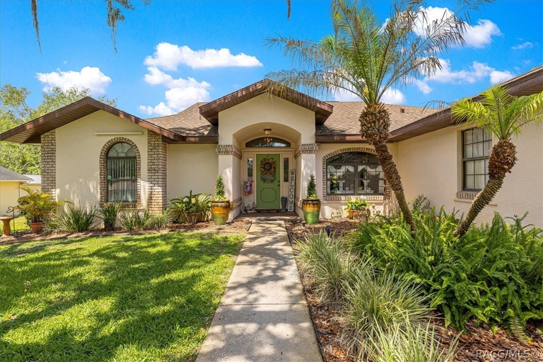 2964 South Cygnet Terrace Inverness, FL 34450 - Photo 2 of 67 a front view of a house with a garden