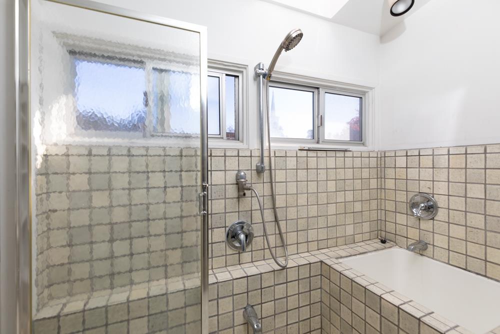 3010 North Main Street Soquel, CA 95073 - Photo 11 of 32 a bathroom with a bathtub a window a sink and shower