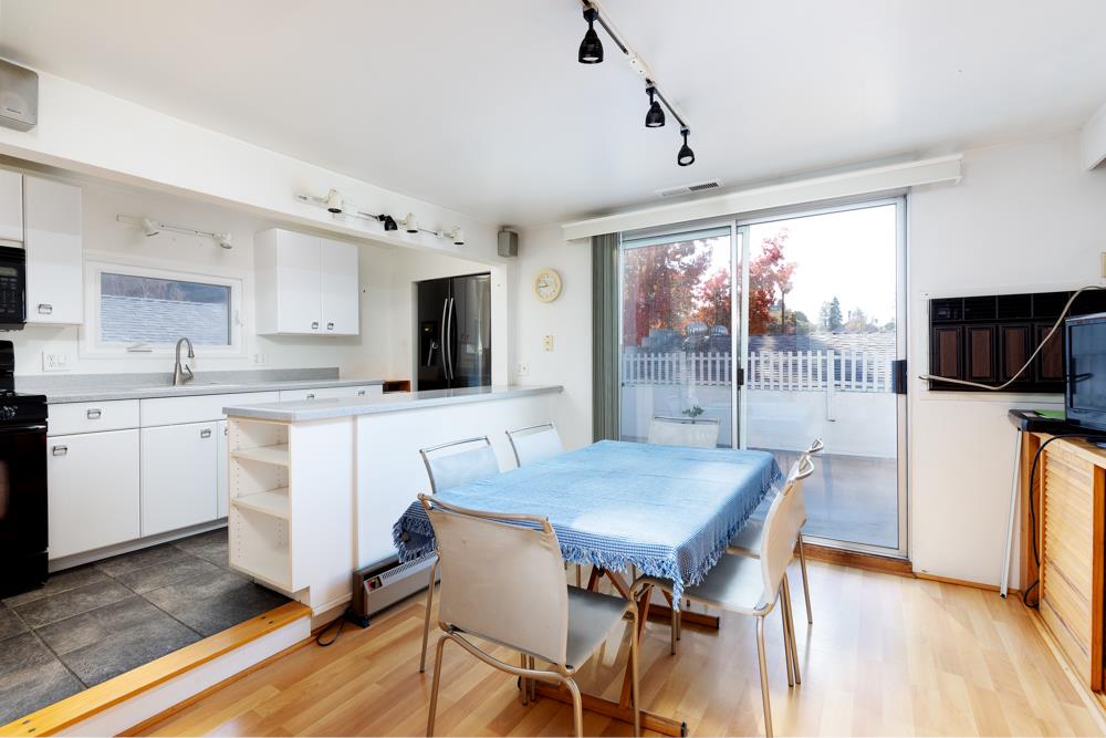 3010 North Main Street Soquel, CA 95073 - Photo 12 of 32 a kitchen with a table chairs refrigerator and cabinets