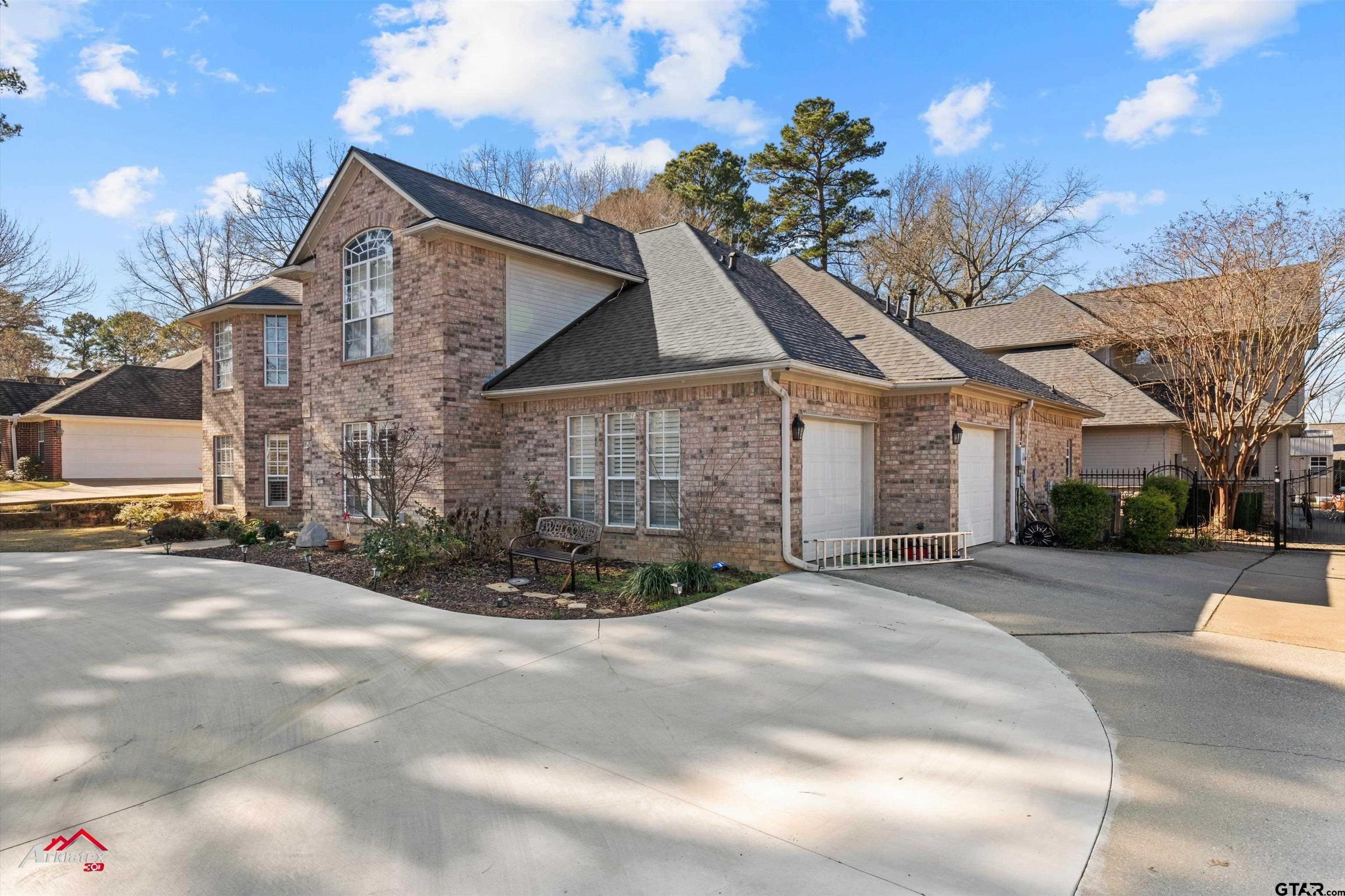 3815 Holly Ridge Drive Longview, TX 75605 - Photo 2 of 22 a front view of a house with a yard and garage