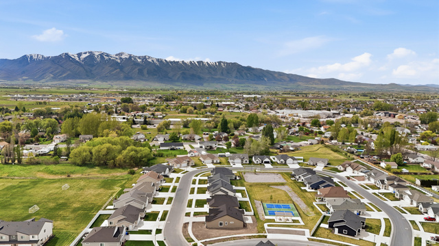 401 West 3085 South, Unit 329 Nibley, UT 84321 - Photo 28 of 34 Aerial perspective of suburban area featuring a mountainous background