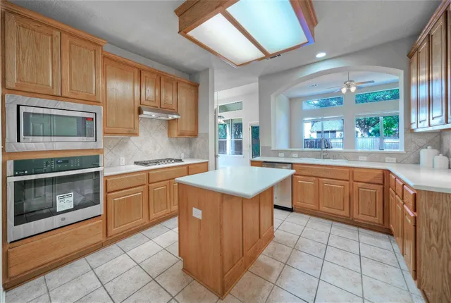 a kitchen with a stove sink and microwave