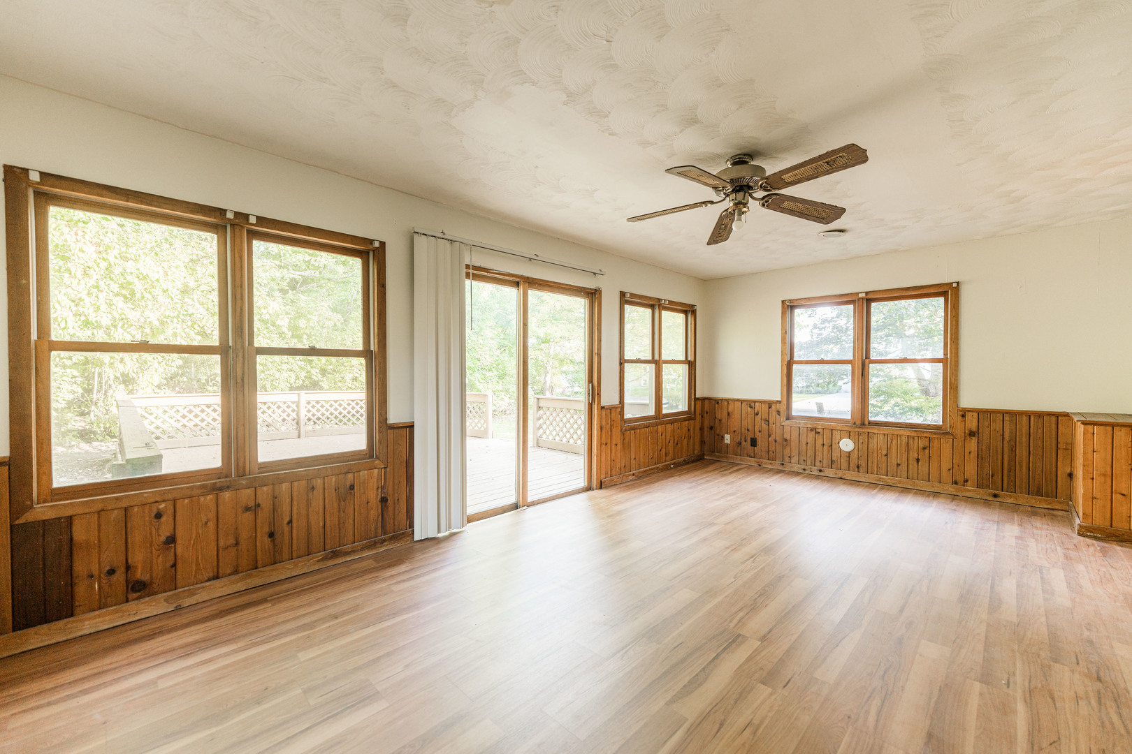 1206 University Drive DeKalb, IL 60115 - Photo 15 of 16 a view of an empty room with a window and wooden floor