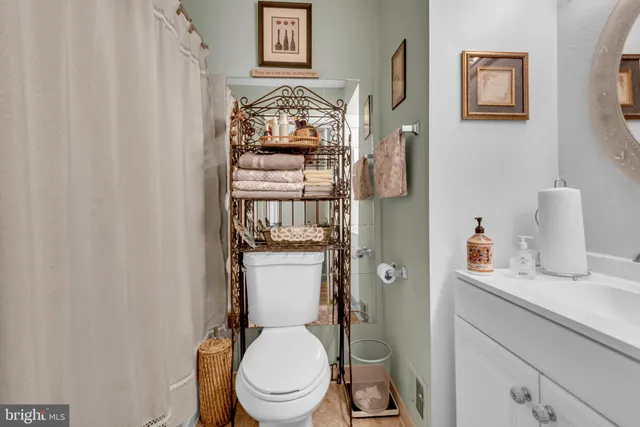 a white toilet sitting next to a bathroom sink