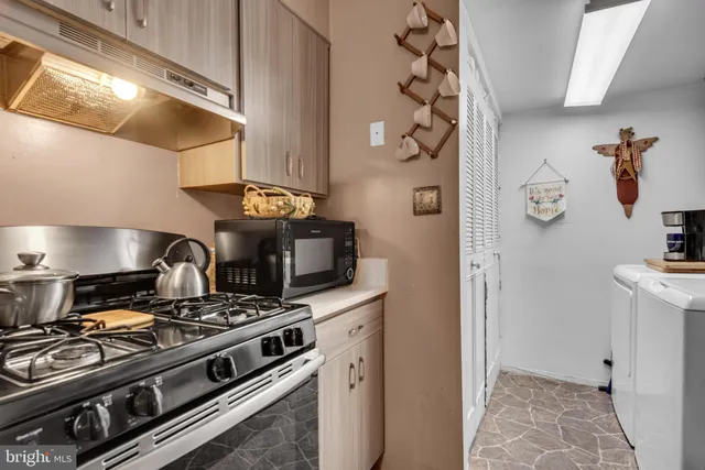 a stove top oven sitting inside of a kitchen