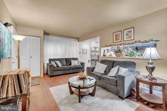 a living room with furniture and a painting