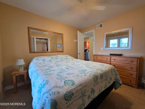a bedroom with a bed and a dresser