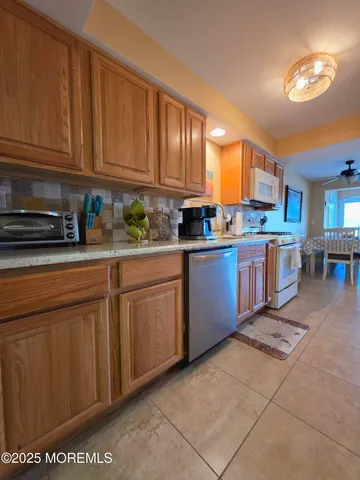 a kitchen with stainless steel appliances granite countertop a stove sink and cabinets