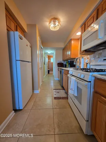 a kitchen with stainless steel appliances granite countertop a refrigerator and a stove