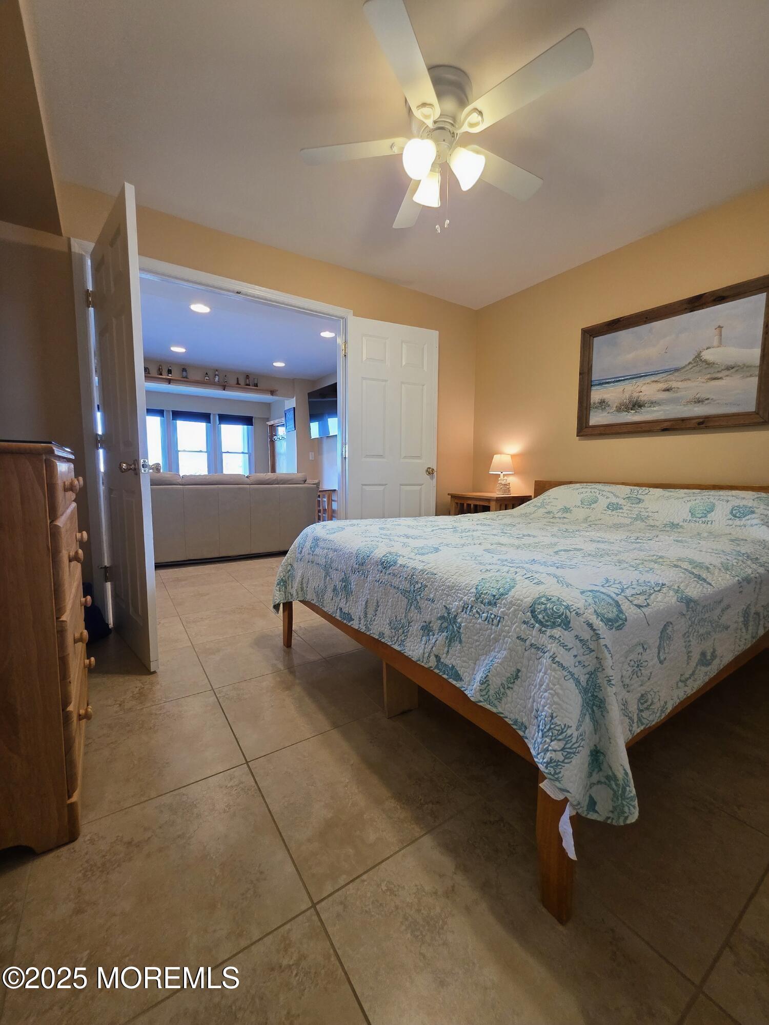 37 Dune Terrace Seaside Heights, NJ 08751 - Photo 9 of 16 a spacious bedroom with a bed and a chandelier
