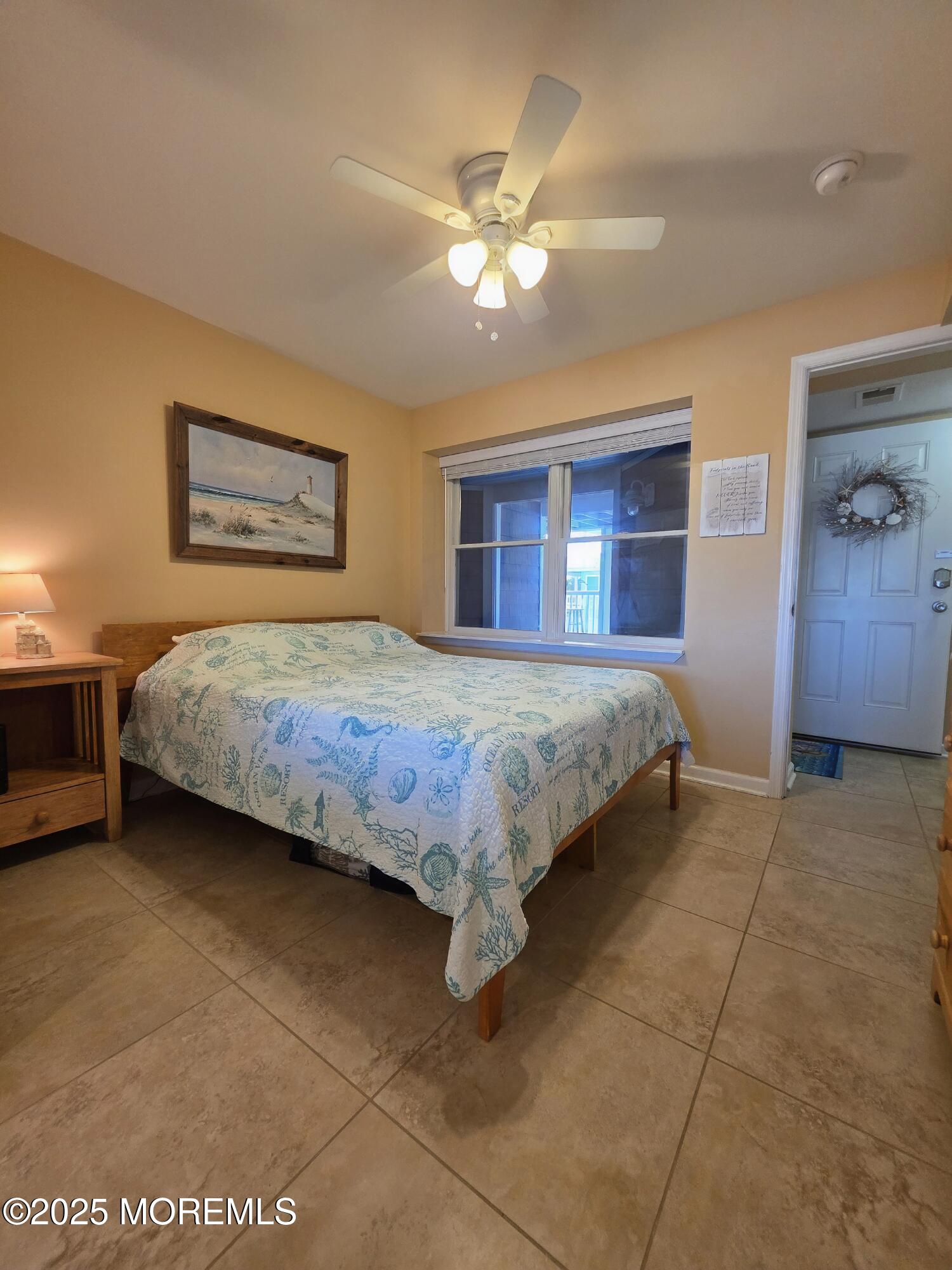 37 Dune Terrace Seaside Heights, NJ 08751 - Photo 10 of 16 a bedroom with a bed and a chandelier