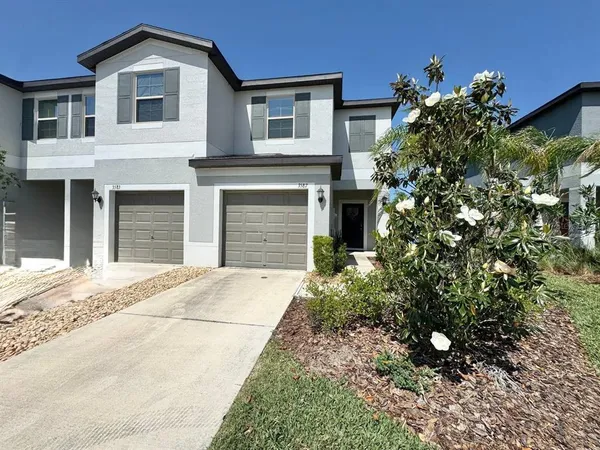 a front view of a house with a garden