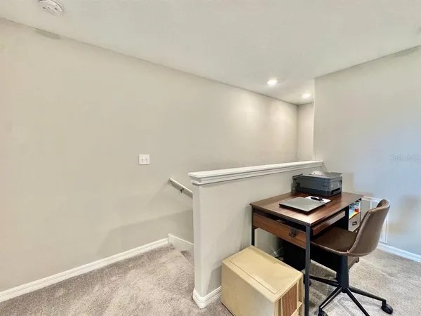 a view of a workspace with furniture