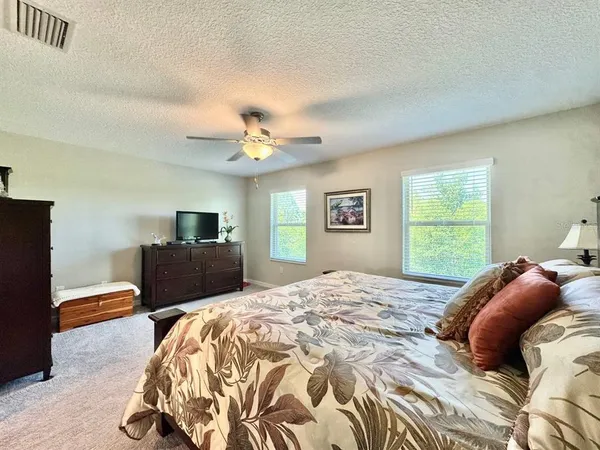 a bedroom with a large bed and a window