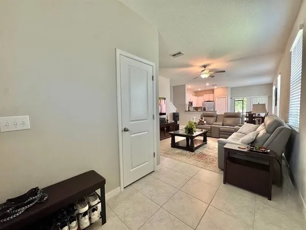 a living room with furniture and a dining table