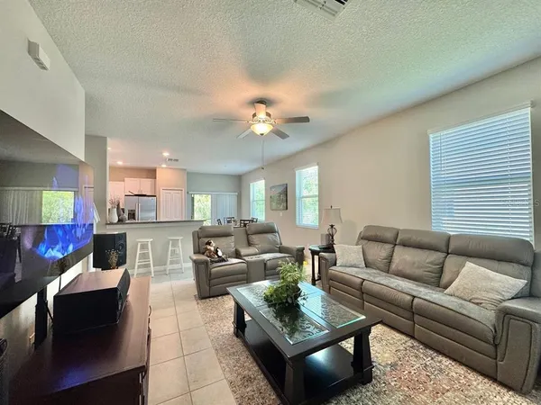 a living room with furniture and a chandelier