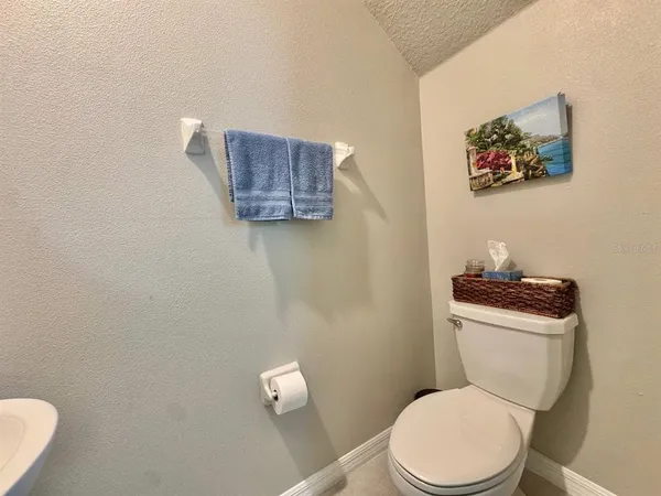 a white toilet sitting next to a bathroom sink