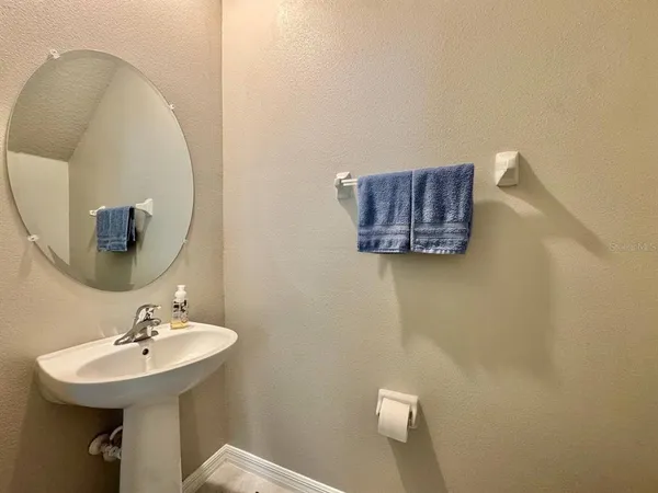 a bathroom with a sink a mirror and a toilet