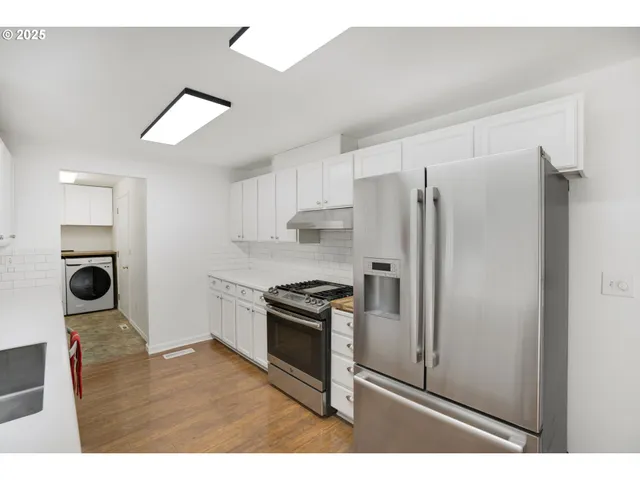 a kitchen with a refrigerator and a stove