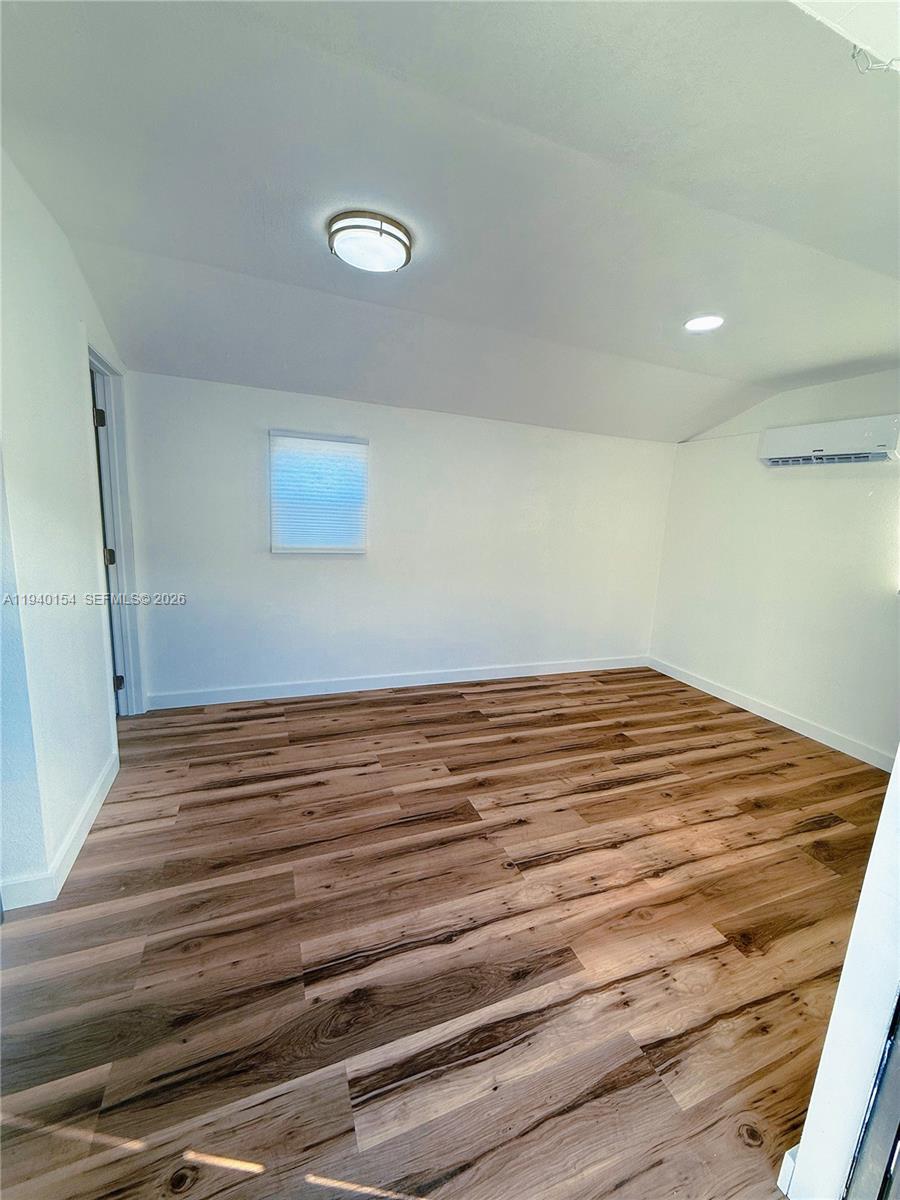 14214 Southwest 289th Terrace, Unit 2 Homestead, FL 33033 - Photo 2 of 6 a view of empty room with wooden floor