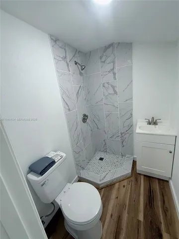 a bathroom with a granite countertop toilet sink and shower
