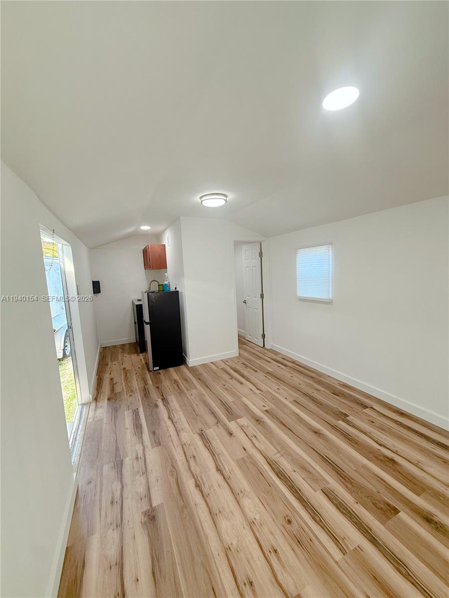 14214 Southwest 289th Terrace, Unit 2 Homestead, FL 33033 - Photo 5 of 6 a bedroom with a bed and a mirror