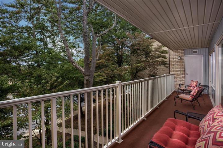 8 Knoll Ridge Court, Unit 1732 Baltimore, MD 21210 - Photo 2 of 20 a balcony with wooden floor stairs and furniture
